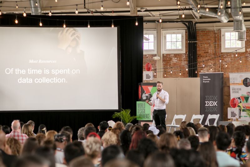 A speaker on stage at a DDX conference edition